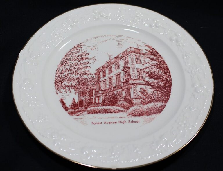 White decorative plate with red drawing of Forest Avenue High School building and trees on the front.
