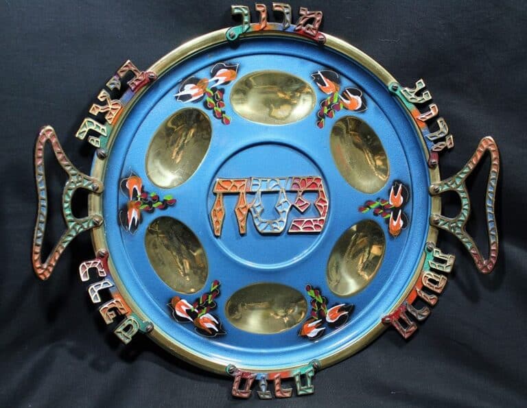 A colorful Passover Seder plate with Hebrew letters and six sections for traditional symbolic foods.
