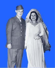 A bride in a wedding dress stands beside a groom in a military uniform, both smiling, on a blue background.