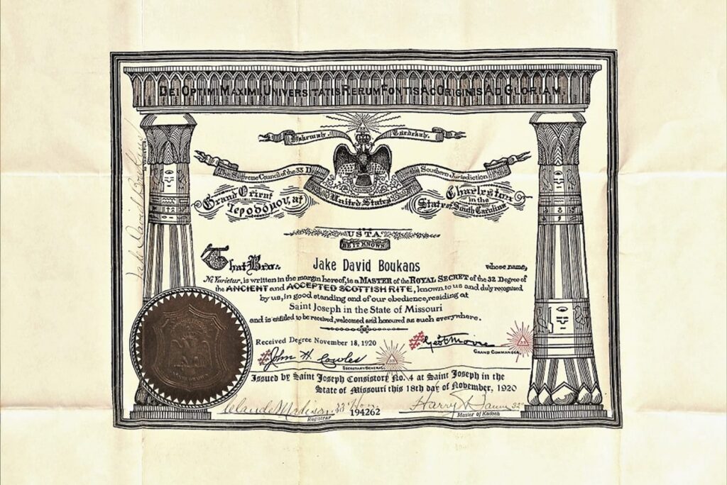 A diploma certificate with ornate borders, a seal, and text awarding a degree to Jake David Bookans.