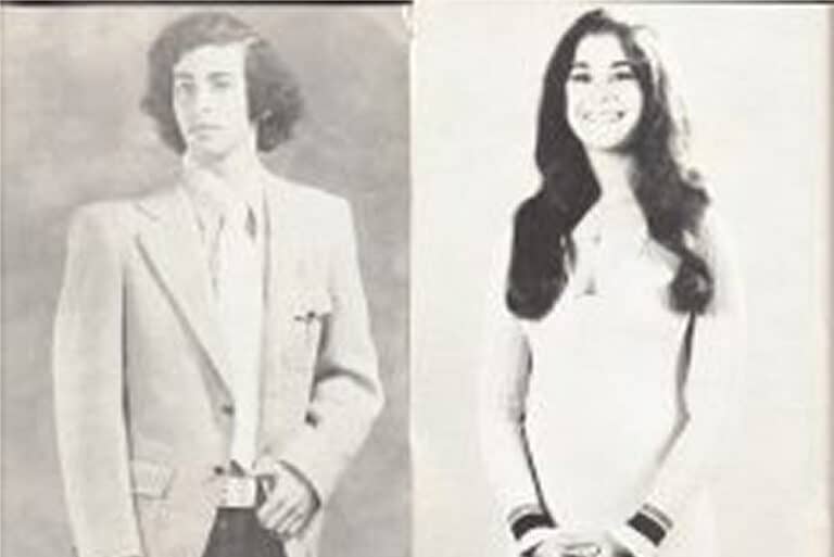 Vintage black-and-white photo of a young man in a suit and a young woman in a dress, both posing and smiling.