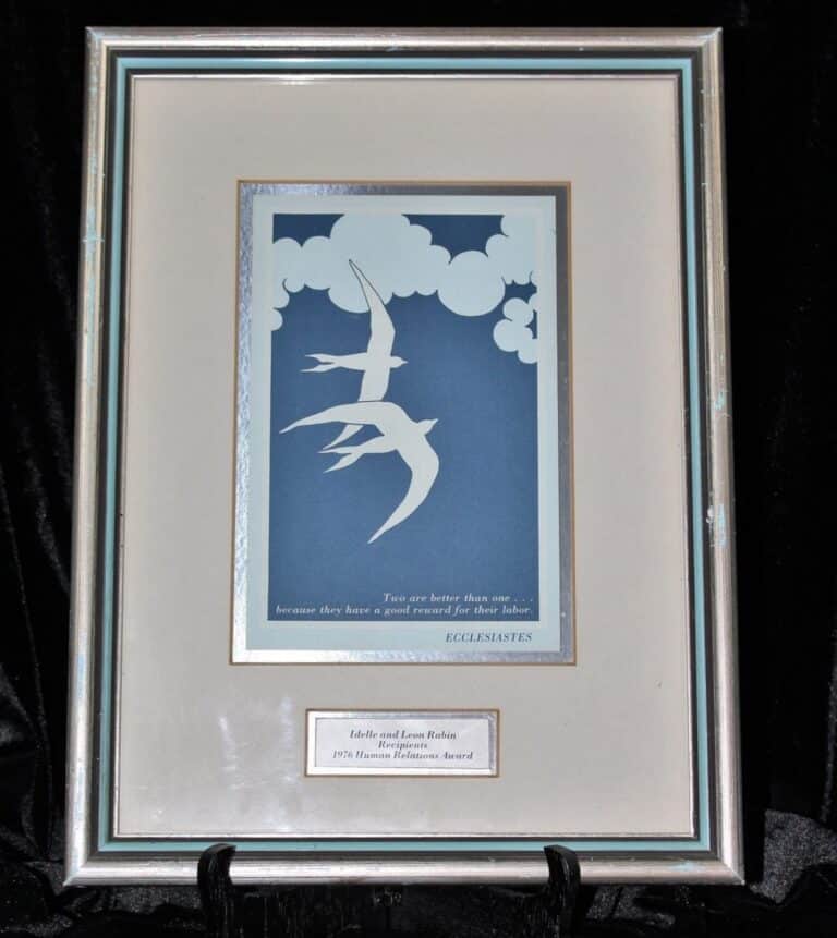 Framed artwork with abstract white bird shapes, clouds, and a quote from Ecclesiastes on a blue background.