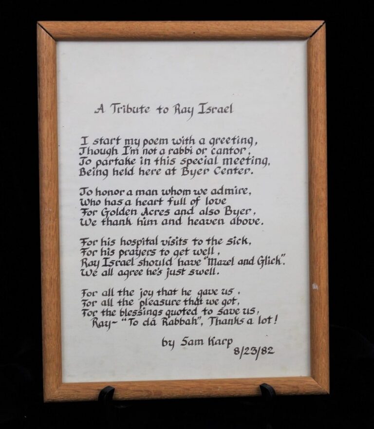 Framed handwritten poem titled “A Tribute to Ray Israel” by Sam Harp, dated 8/23/82, in black ink on white paper.