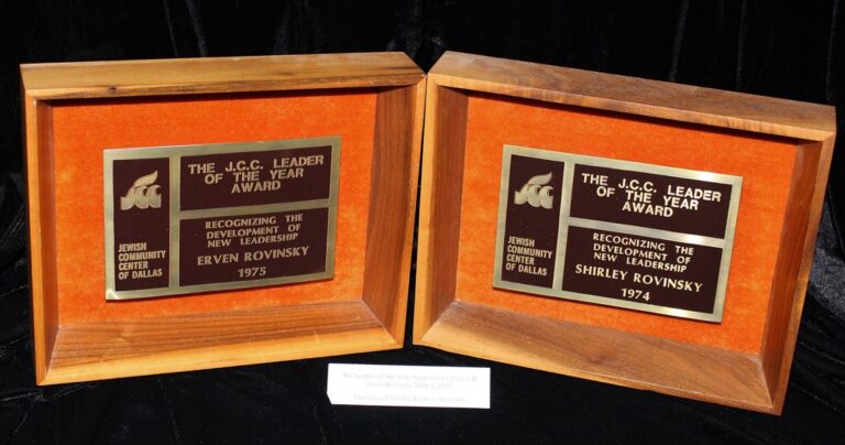 Two wooden plaques read “J.C.C. Leader of the Year Award” for Erven and Shirley Kovinsky, 1975 and 1974.
