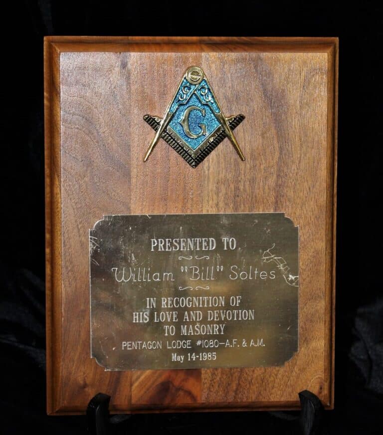Wooden plaque with Masonic symbol, engraved plate honoring William “Bill” Soltes for devotion to Masonry, dated May 14, 1985.