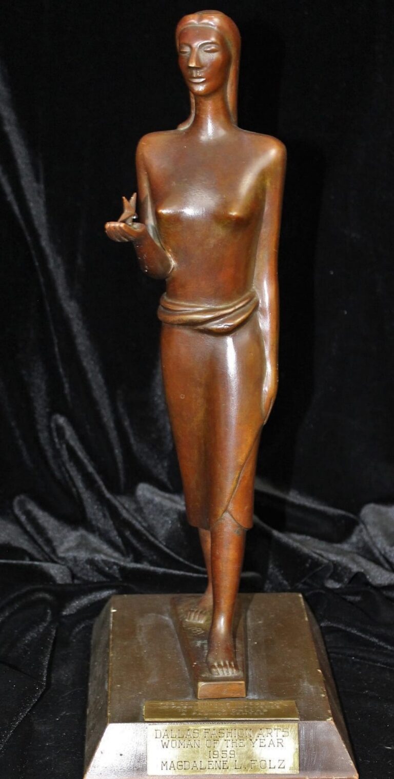 Bronze statue of a standing woman holding a dove, mounted on a rectangular base with a plaque.