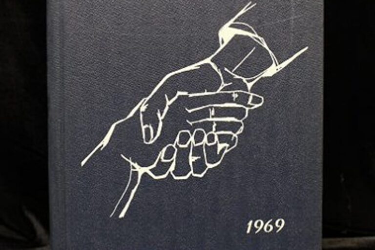 A black book cover with a white line drawing of two hands holding and the year 1969 printed in the bottom right corner.