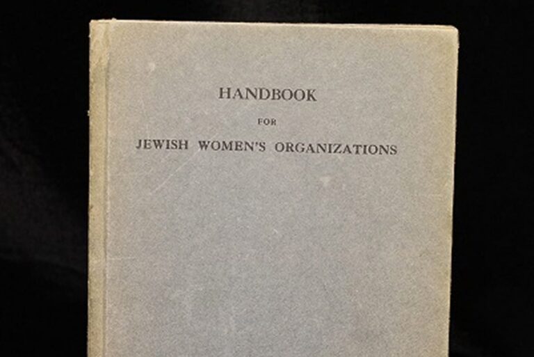 A gray book cover titled “Handbook for Jewish Women’s Organizations” against a black background.