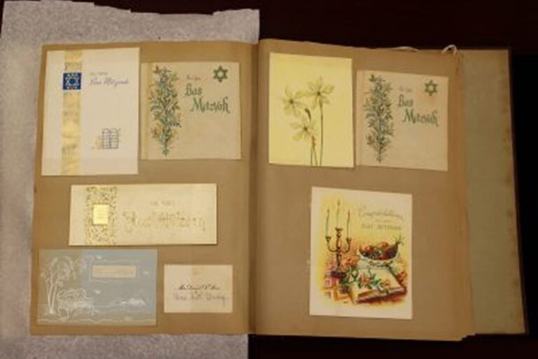 A scrapbook page displays Bar Mitzvah cards, floral cards, and a card with a menorah and candles.